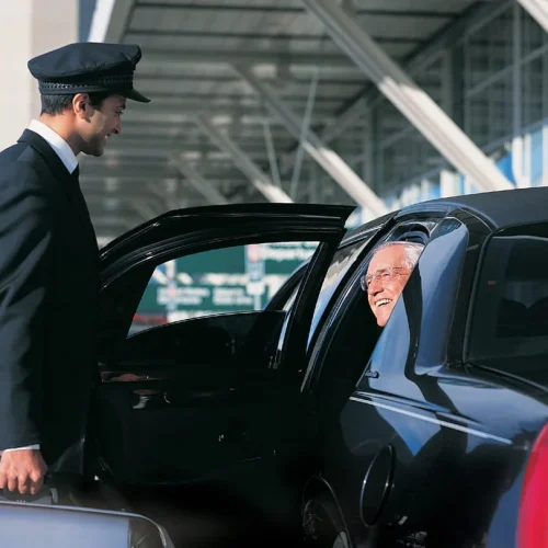 driver holding door while man coming out of the car