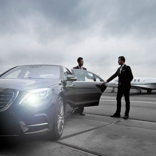 two men standing near car